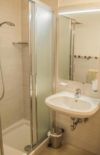 a bathroom with a sink and a shower at Hotel Italia in Sacile