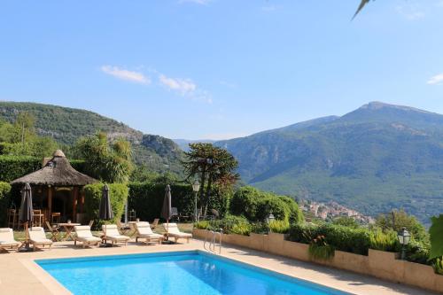 a swimming pool with a view of a mountain at Loup Castel Boutique Hotel B&B in Le Bar-sur-Loup
