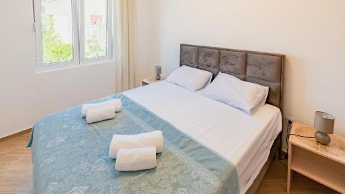 a bedroom with a large bed with two white pillows at Zeleni in Đenovići