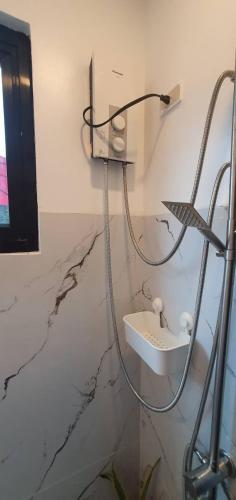 a bathroom with a sink on a marble wall at West Atlantic Inn in Concepcion