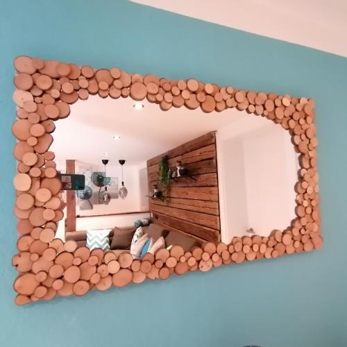 an arch shaped mirror on the wall of a room at Ferienwohnung Berg(Aus)zeit Ennstal in Öblarn
