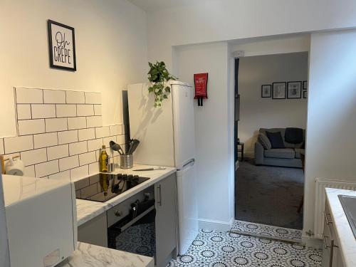 a kitchen with a sink and a refrigerator at Balfour B - Fully refurbished 2 bedrooms Ideal for Contractors and Families Free wifi Free Parking Ground Floor in Gateshead