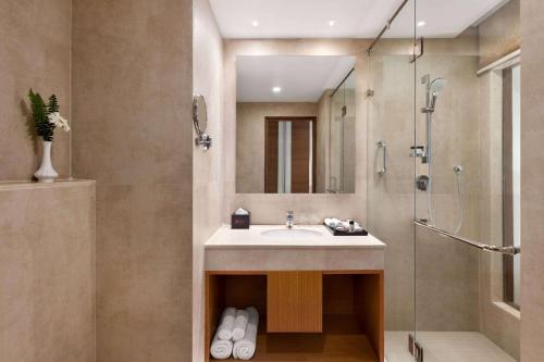 a bathroom with a sink and a shower at Ramada Encore by Wyndham Kathmandu Thamel in Kathmandu