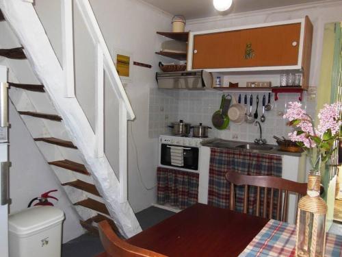 a small kitchen with a table and a staircase at 1882 Vintage in Drymon