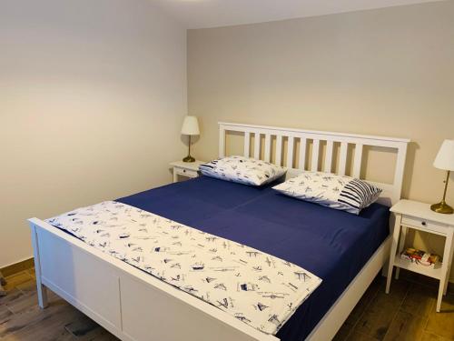 a bed in a bedroom with two pillows on it at Apartment Murvica in Pag