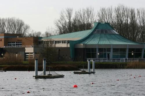 a building with a green roof in a body of water at Holiday Apartment Al 't Sanna in Geraardsbergen