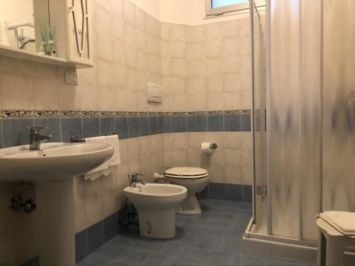 a bathroom with a sink and a toilet and a shower at Hotel Eden in Padova