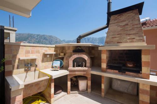 a large outdoor pizza oven on a house at Apartments Bonaca in Kotor