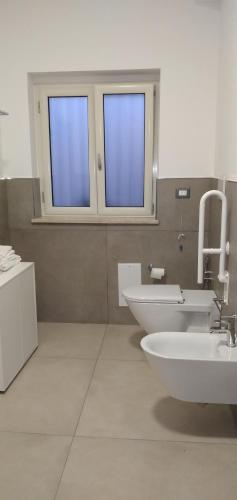 a bathroom with two sinks and two windows at B&B Tenuta San Michele in Capaccio-Paestum