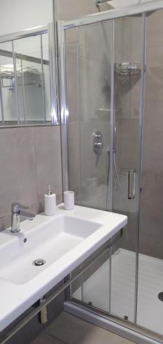 a bathroom with a white sink and a shower at B&B Tenuta San Michele in Capaccio-Paestum