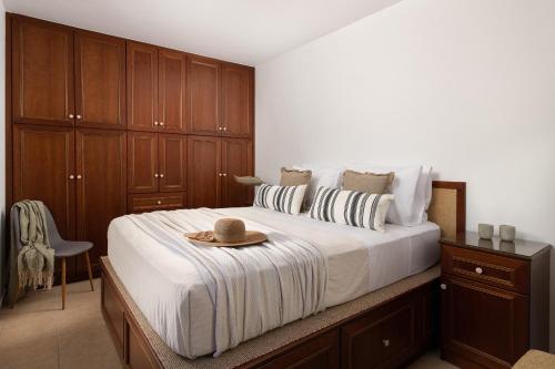 a bedroom with a bed with a hat on it at Lindos Luxury Belfry Apartment in Lindos