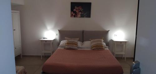 a bedroom with a large bed with two night stands at B&B Tenuta San Michele in Capaccio-Paestum