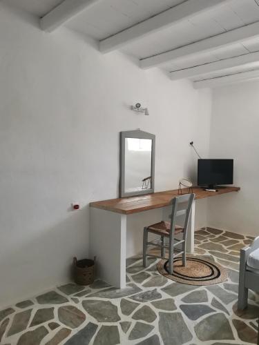 a room with a desk with a mirror and a chair at Soros Beach Antiparos in Agios Georgios