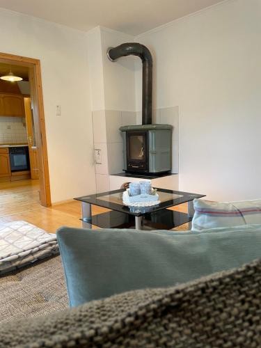 a living room with a stove in a room at Almhaus Kochjosel in Garanas