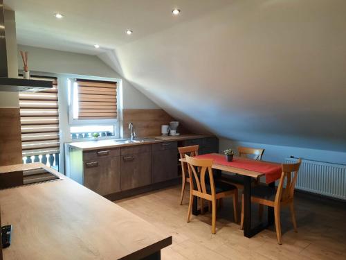 a kitchen with a table and chairs and a sink at Geishöhe Landgasthof Rose Dammbach in Dammbach
