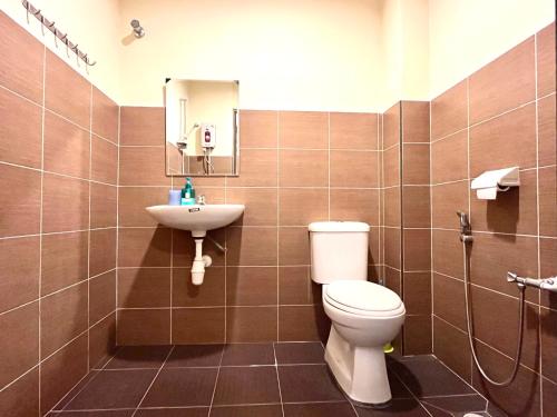 a bathroom with a toilet and a sink at VGO House in Malacca