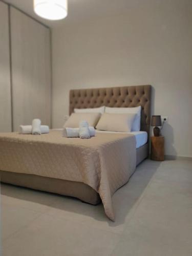 a bedroom with a large bed with white pillows at Ilenia Guesthouse in Zagora