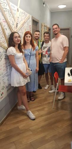 a group of people standing next to a wall at Gloria Hostel Milano in Milan