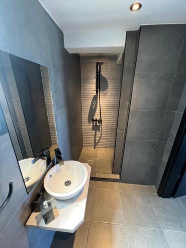 a bathroom with a sink and a shower at MEDORA By the Sea Near Airport in Artemida