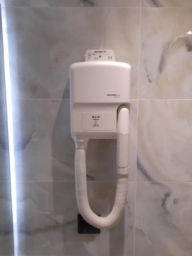 a white urinal with a white pipe in a bathroom at Cabo Verde in Agia Triada