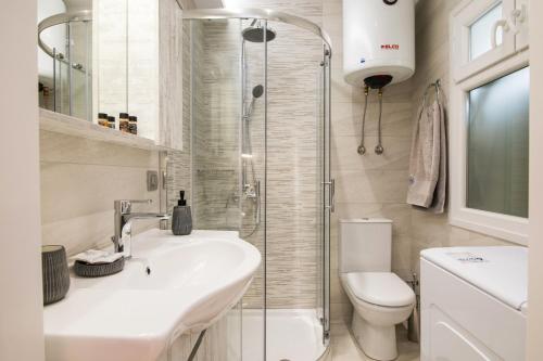 a bathroom with a shower and a sink and a toilet at Electra's house in Corfu Town