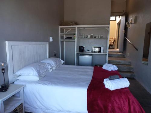 a bedroom with a large bed with two towels on it at Eagle's Crest in Worcester
