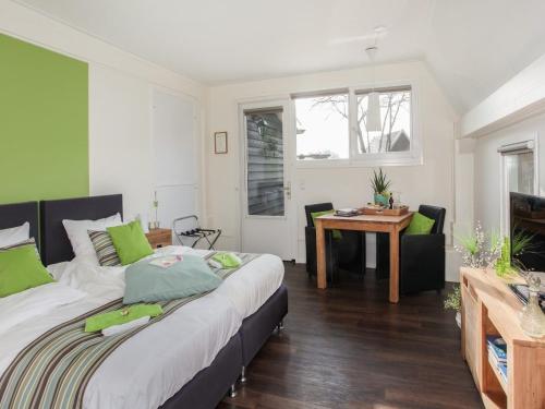 a bedroom with a bed and a table and a desk at Rheezerstee in Rheeze