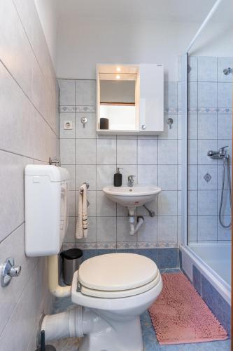 a bathroom with a toilet and a sink at Apartman Antonija in Cres