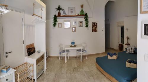 a room with a bed and a table and chairs at Dimora del Pescatore in Manfredonia