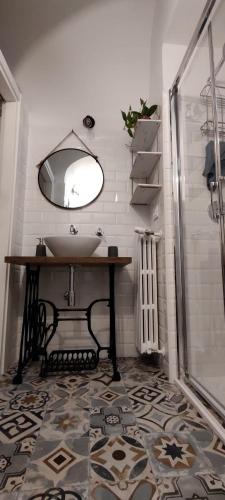 a bathroom with a sink and a mirror at Dimora del Pescatore in Manfredonia