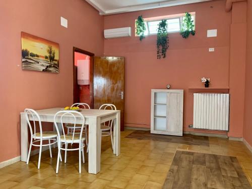 a dining room with a white table and chairs at Nonna Maria Sweet Home in Castellana Grotte