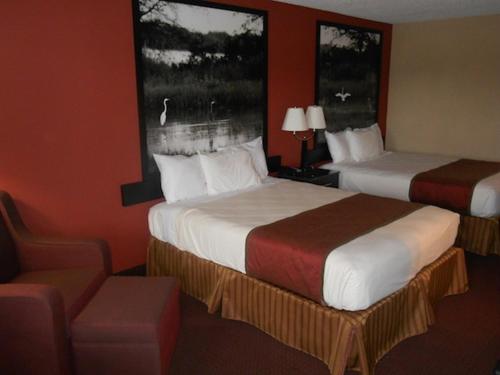 A bed or beds in a room at AmeriStay Inn St Joseph