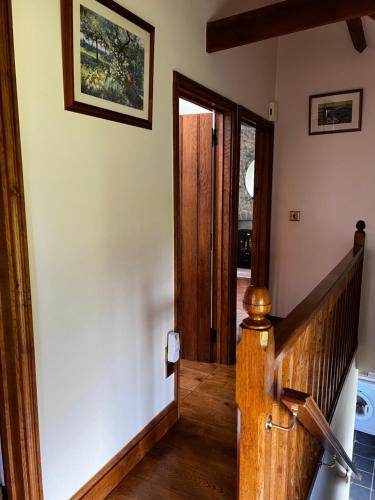 a hallway with a wooden door in a house at Cwmgwn Farm in Llandovery