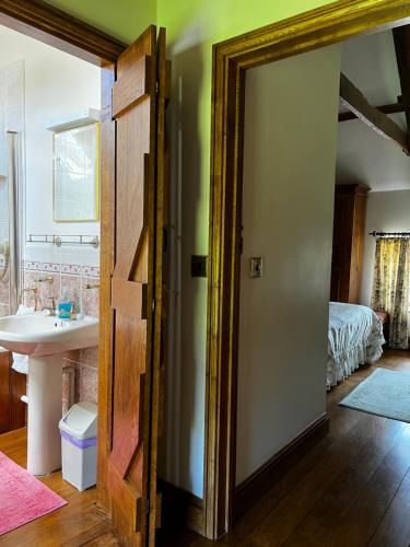 an open door in a room with a bedroom at Cwmgwn Farm in Llandovery