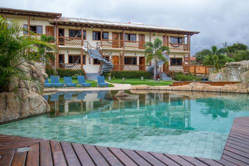 a swimming pool in front of a resort at Pousada dos Guias in Alto Paraíso de Goiás