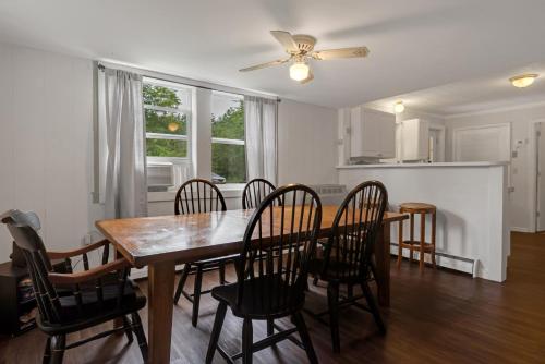 a kitchen and dining room with a table and chairs at Two Brooks Lodge in Bennington