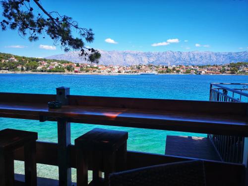 a view of the water from a bar with chairs at Wiew in Selca