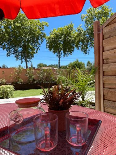 a table with glasses on top of a table at Gîte Marsau in Lacourt-Saint-Pierre
