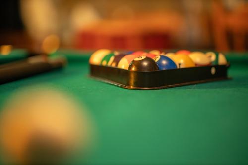 a tray of pool balls on a pool table at Blauwe Hoeve Luxe, ruimte, privacy en rust in Retranchement
