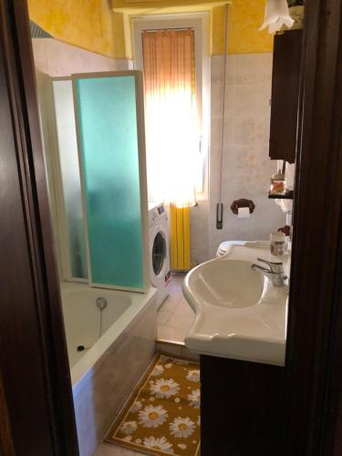 a bathroom with a sink and a shower and a tub at La casa di Marco in Imperia