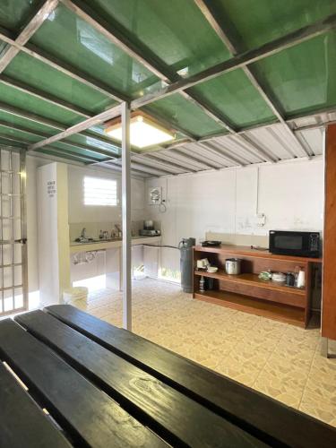 a large kitchen with a table in a room at Caye Caulker Beach Hotel in Caye Caulker