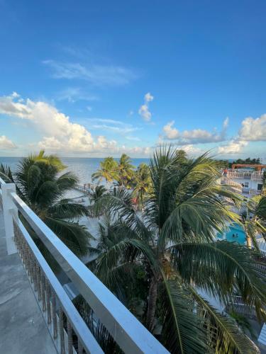 a view of the ocean from the balcony of a resort at Caye Caulker Beach Hotel in Caye Caulker