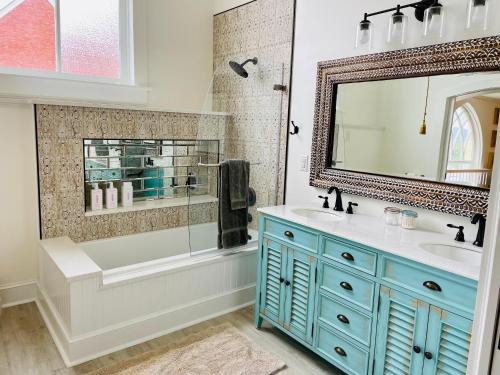 a bathroom with a blue sink and a mirror at The Sanctuary:Downtown Staunton in Staunton