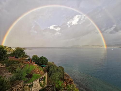 a rainbow in the sky over a body of water at Ece Hotel Sovalye Island in Fethiye