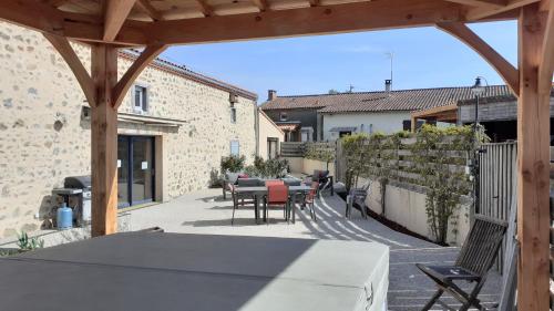 an outdoor patio with a table and chairs at LES GALAINES in Abzac