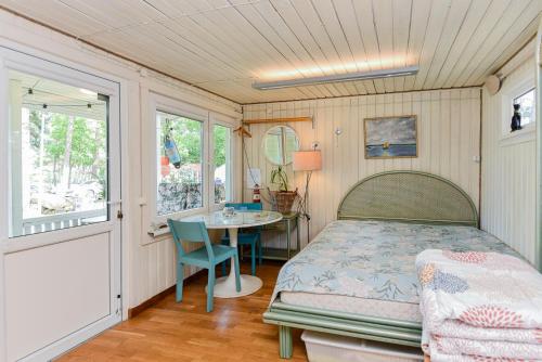 a bedroom with a bed and a table in it at Undinėlė in Šventoji