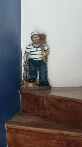 a statue of a man standing on top of a stairs at ANCRE BLEU in Hillion