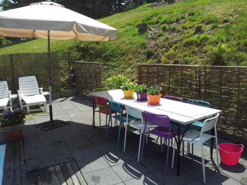 a patio area with chairs, tables and umbrellas at B&B Orchidee in Altenau
