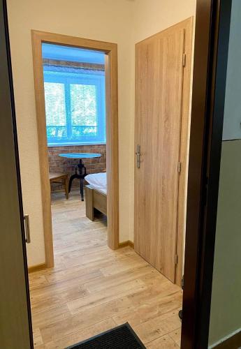 a hallway with a door and a table in a room at Tatranská garsónka in Smokovce