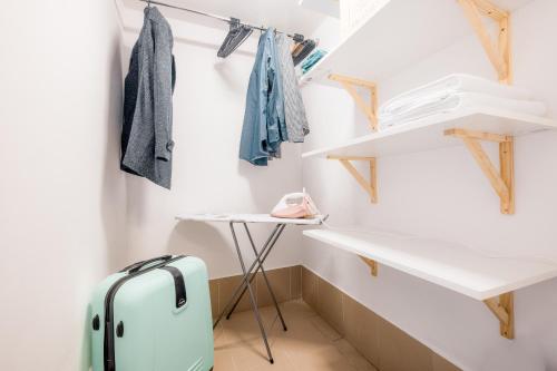 a small closet with a suitcase in a room at Eromeni Apartments in Biały Dunajec